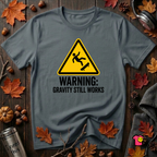 Warning Gravity Still Works sarcastic graphic t-shirt in Dark Gray by Snarky Sarks