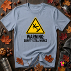 Warning Gravity Still Works sarcastic graphic t-shirt in Heather Prism Blue by Snarky Sarks
