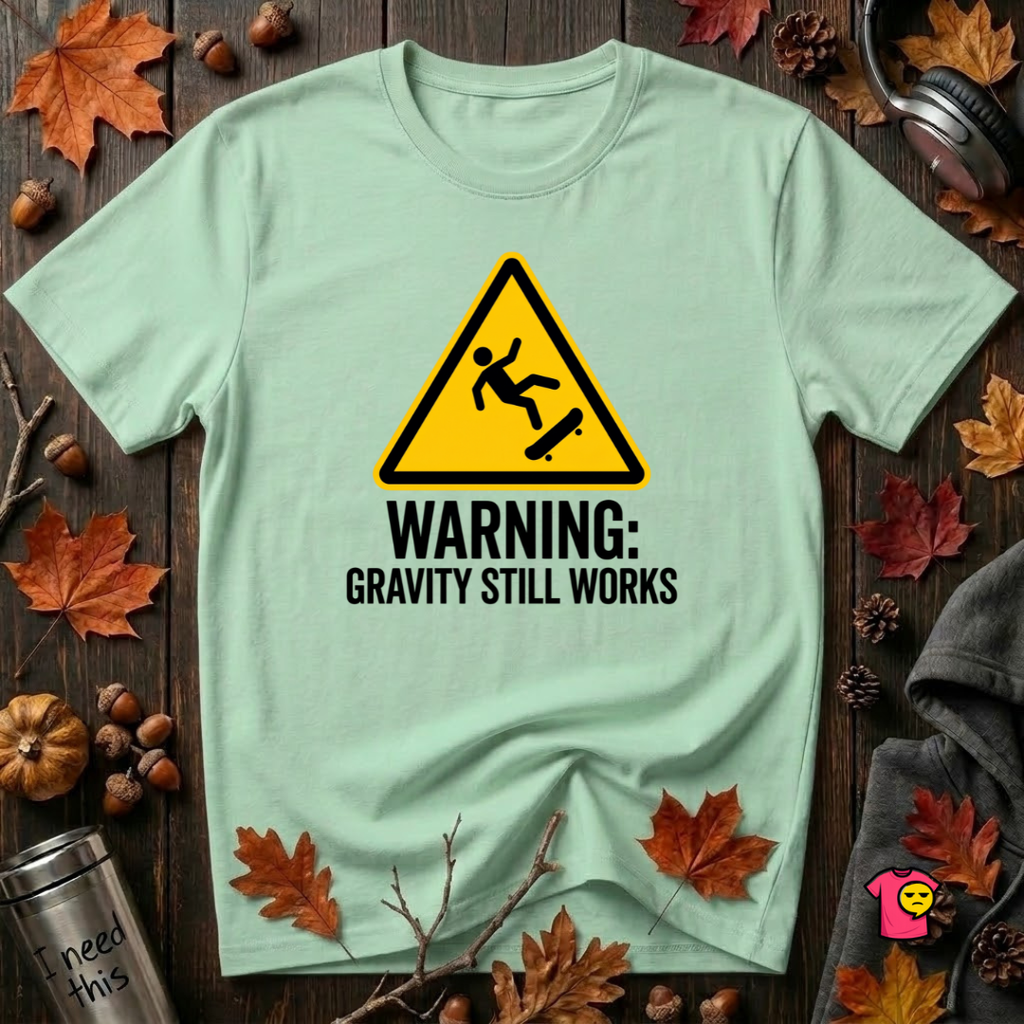 Warning Gravity Still Works sarcastic graphic t-shirt in Mint by Snarky Sarks