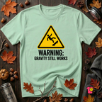 Warning Gravity Still Works sarcastic graphic t-shirt in Mint by Snarky Sarks