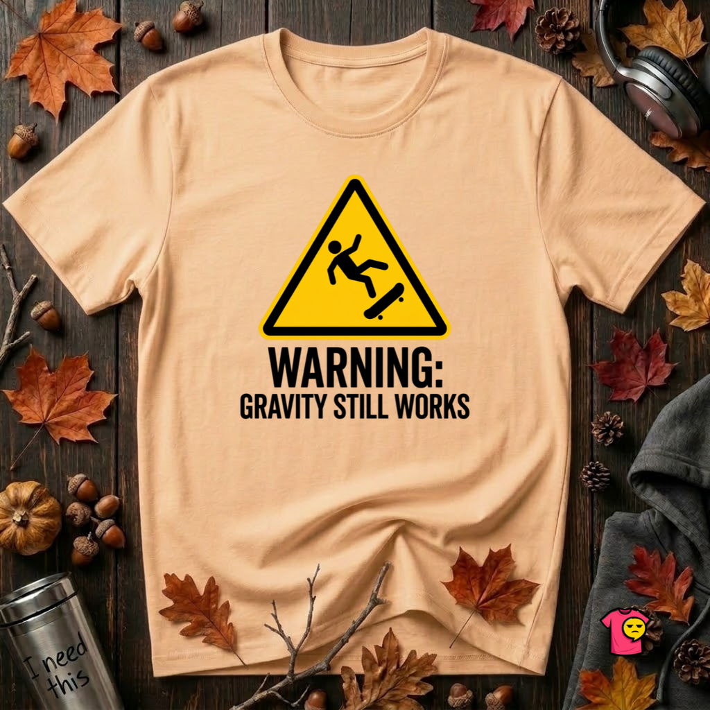 Warning Gravity Still Works sarcastic graphic t-shirt in Peach by Snarky Sarks