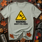 Warning Gravity Still Works sarcastic graphic t-shirt in Sage by Snarky Sarks