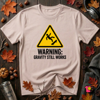 Warning Gravity Still Works sarcastic graphic t-shirt in Soft Pink by Snarky Sarks