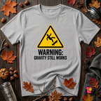Warning Gravity Still Works sarcastic graphic t-shirt in Solid Athletic Gray by Snarky Sarks
